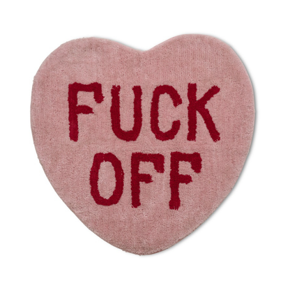 Pink heart-shaped rug with the words Fuck Off printed in red