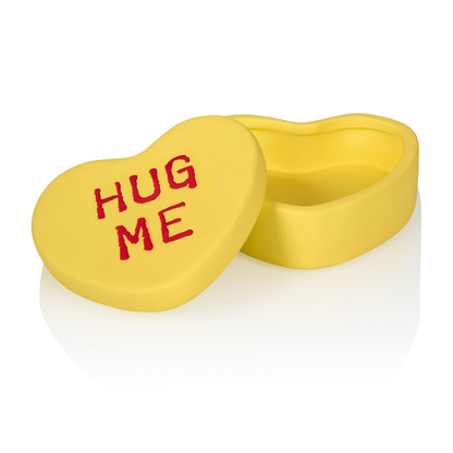 Hug Me heart box in yellow, open on a white background, seen from above.