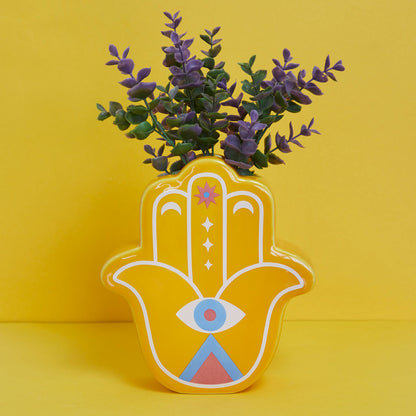 Yellow Lucky Hand vase with purple leaves on a yellow background