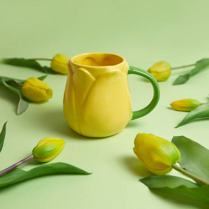Yellow Tulip mug on a green background surrounded by yellow tulips