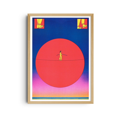 Framed poster of a figure balancing on a tightrope in front of a red sun