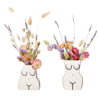 Vasi Body Duo white female body-shaped vases, filled with lilac and yellow dried flowers.