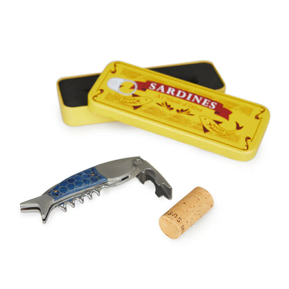 Sardines corkscrew blue fish-shaped tool resting next to the open tin and a cork.