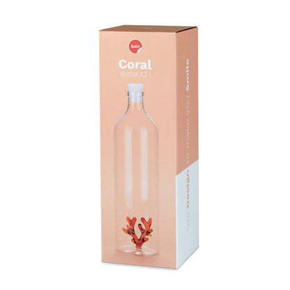 The coral bottle shown in its peach-coloured box