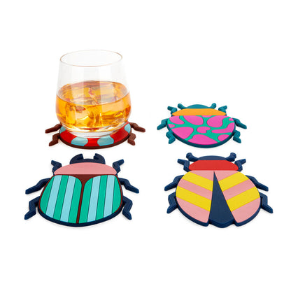 Beetle coasters, with a whisky glass resting on one of them.