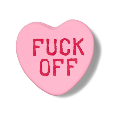 Fuck Off heart-shaped box in pink, closed, with the red lettering visible on the lid.