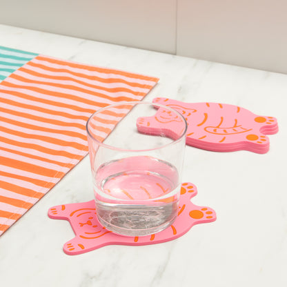 Tiger coasters on a marble table, with a glass of water resting on one