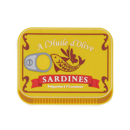 Trivet shaped like a yellow sardine tin can, on a white background