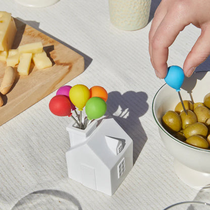 House Balloon snack forks holder shaped like a white house, with colourful balloon forks and olives.