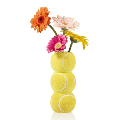 Ace Tennis Ball vase made of three stacked balls, styled with pink and orange gerberas.