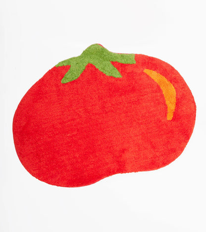 Red tomato-shaped rug with a green stem, on a white background